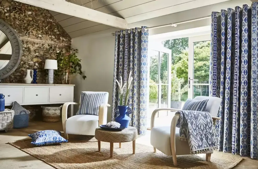 Full-height curtains installed in a furnished interior